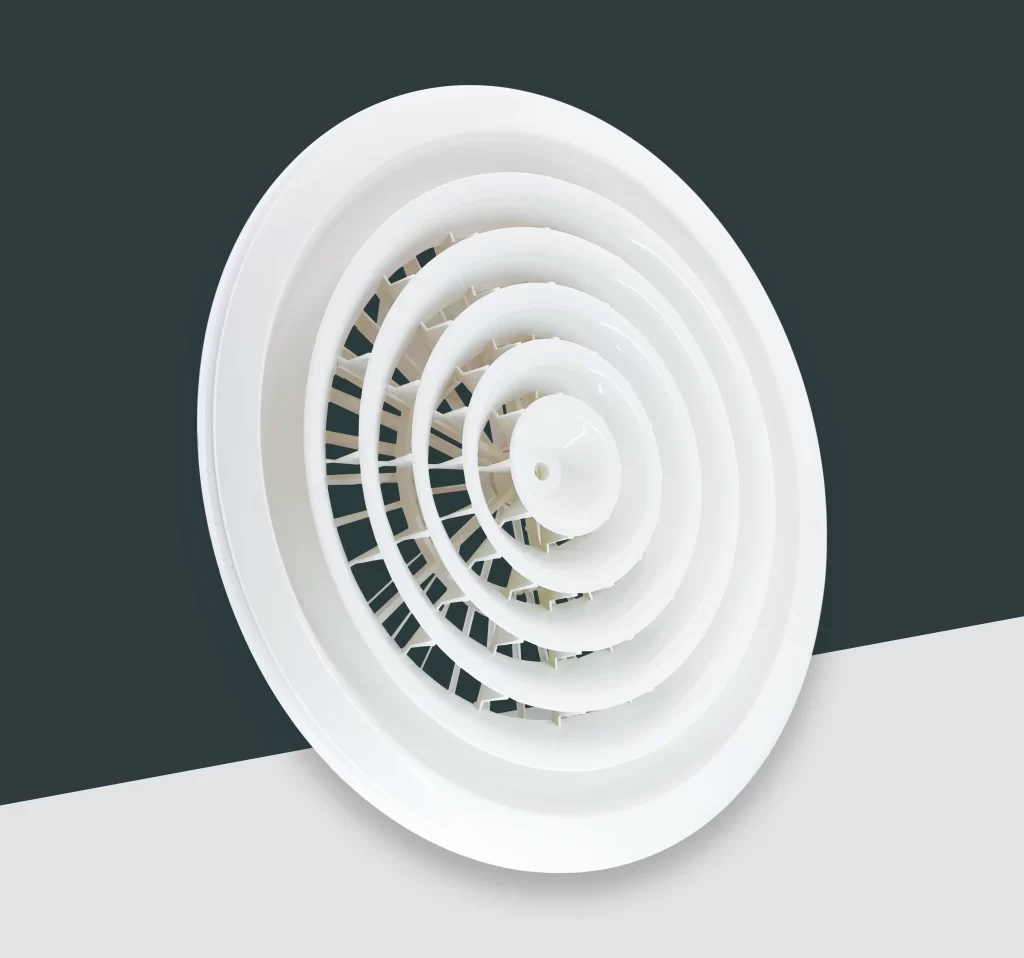 Close - up of the ABS - 003AB circular rotating (diffusion - type) air outlet. It has a white, multi - layered, spiral - like structure, designed for uniform air diffusion in cleanroom environments, placed against a black and white background.