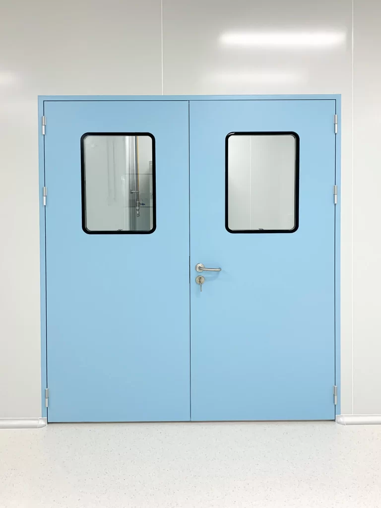 Light blue double-leaf airtight door with symmetric vision panels and metal locking mechanism. Illustrates interlocked structure to prevent cross-contamination in multi-zone lab environments.