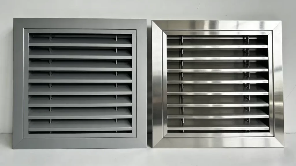 Side-by-side comparison of two cleanroom vent grilles: left is matte aluminum, right is brushed stainless steel.