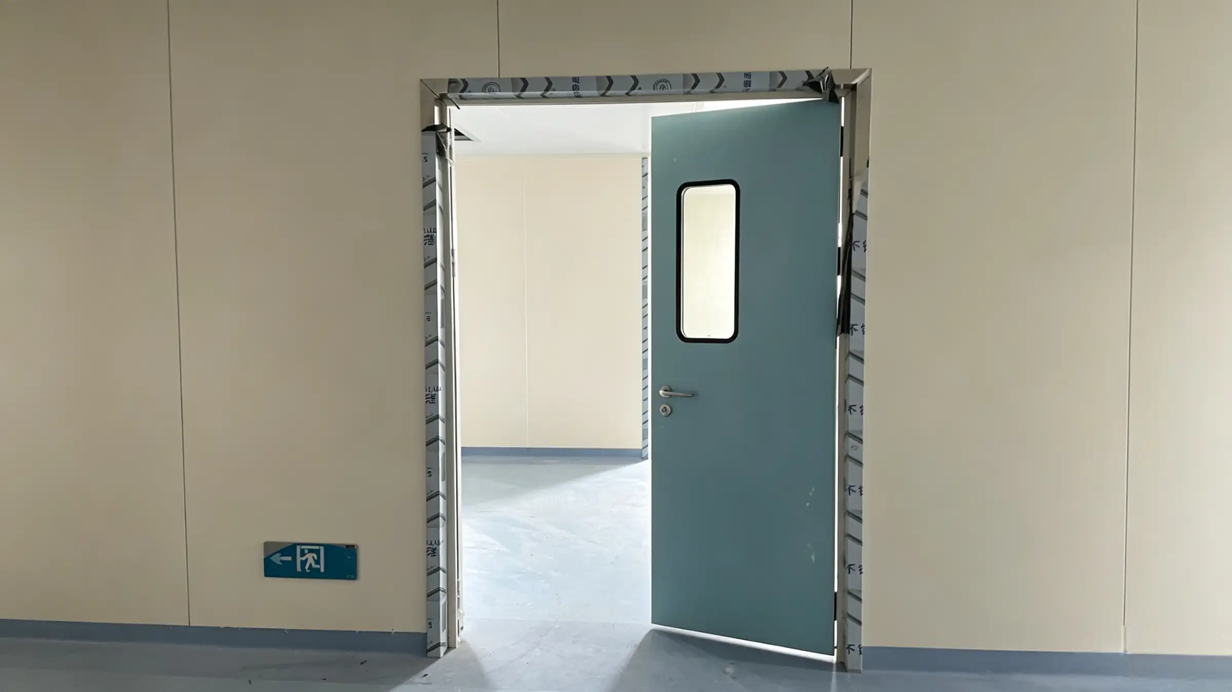 Single blue Airtight Automatic Door with a viewing window installed in a hospital cleanroom corridor.