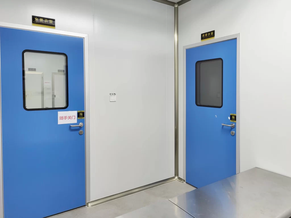 Pair of standard hygienic non-airtight cleanroom doors for staff changing buffer areas, low-risk ISO8 support zones without full hermetic sealing demand.