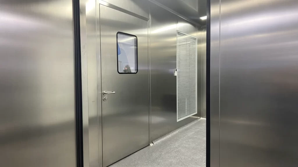 Full SUS304 steel cleanroom single door inside pharmaceutical Grade A/B core production cleanroom, metal wall panels, sealed small sight glass.