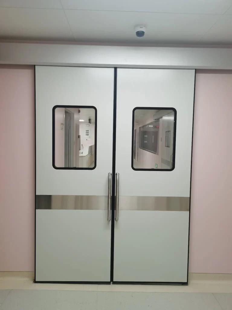 Cleanroom double sliding doors with vision panels and stainless steel kick plates