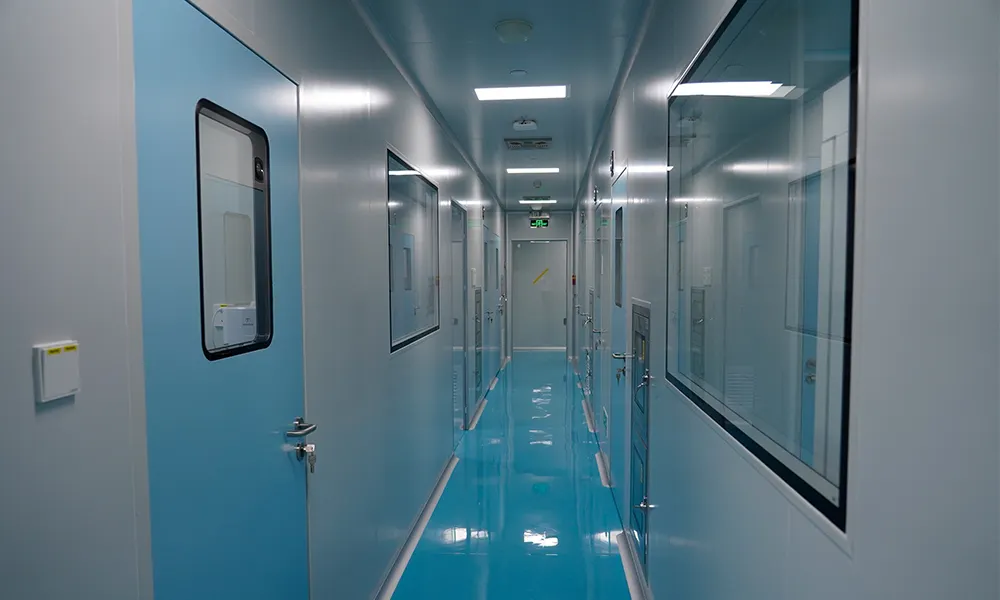 Pharmaceutical cleanroom corridor lined with blue steel cleanroom doors and flush vision panels