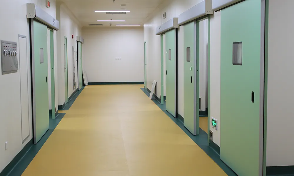 Hermetic sliding cleanroom doors with vision panels in a pharmaceutical facility hallway