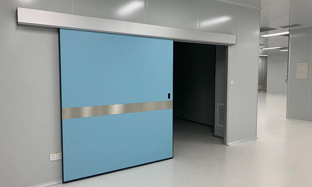 Blue sliding cleanroom door in a gray-walled cleanroom facility with a stainless steel accent stripe
