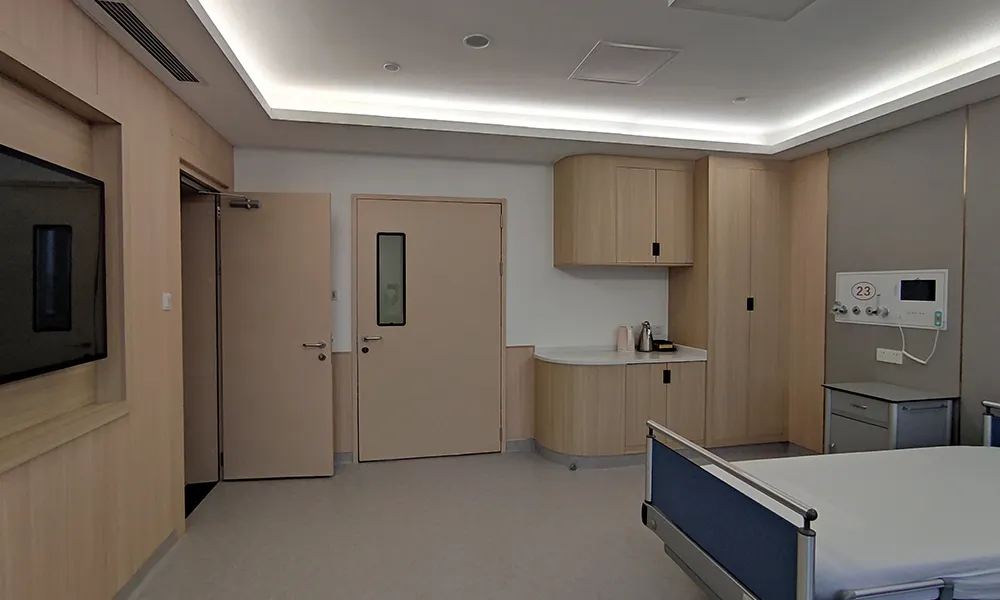 Modern acoustic hospital room door with vision panel installed in a quiet patient ward for sound insulation and privacy.