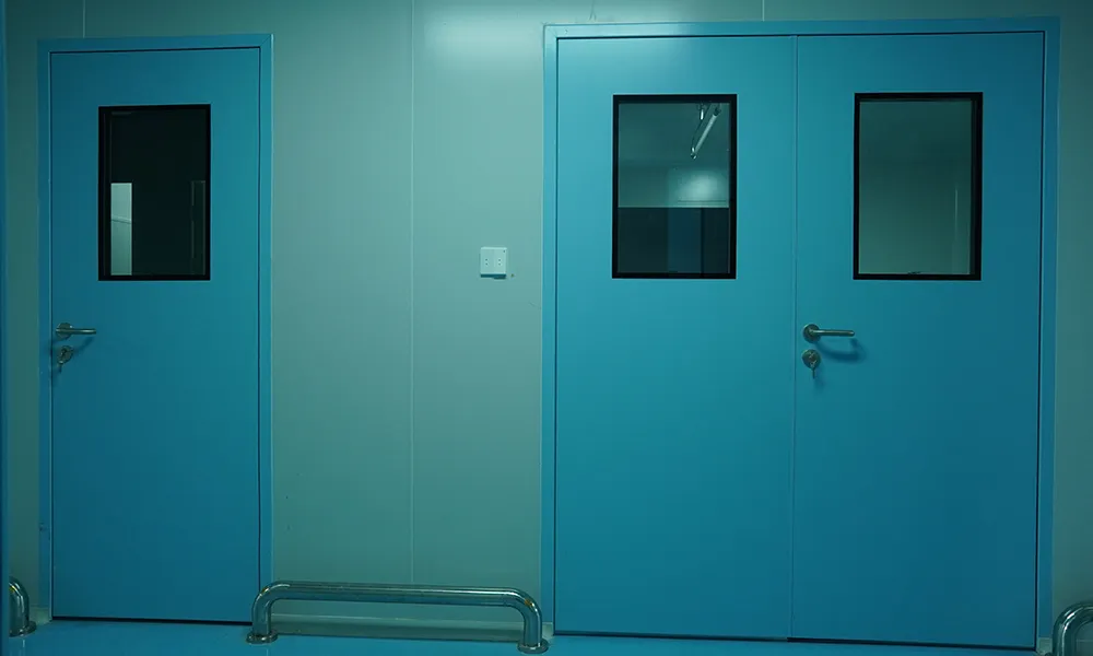 Blue cleanroom swing doors with glass view windows for personnel and material airlock entrances